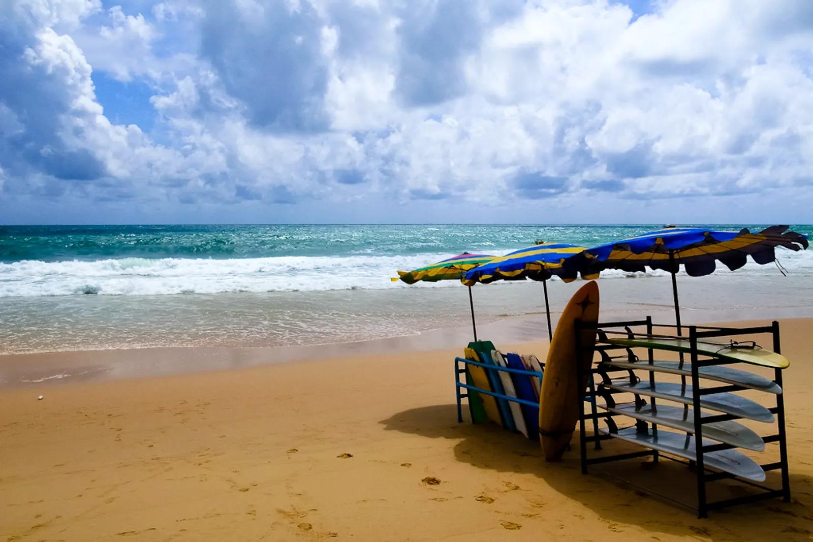 Surin beach, Phuket - golden sand, turquoise surf and surfboards under parasols